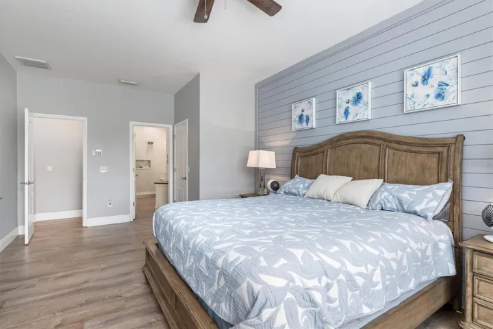 Primary bedroom has shiplap accent wall.