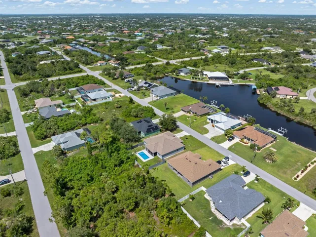 Circular street with gulf-access homes on one side.