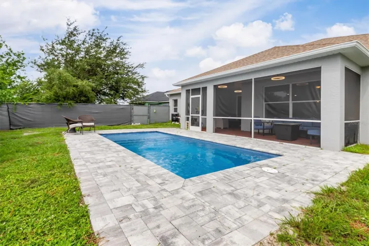 Pavers around pool allow for sunbathing.