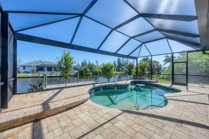view of pool, dock and waterfront-beautiful view with "picture window" screen