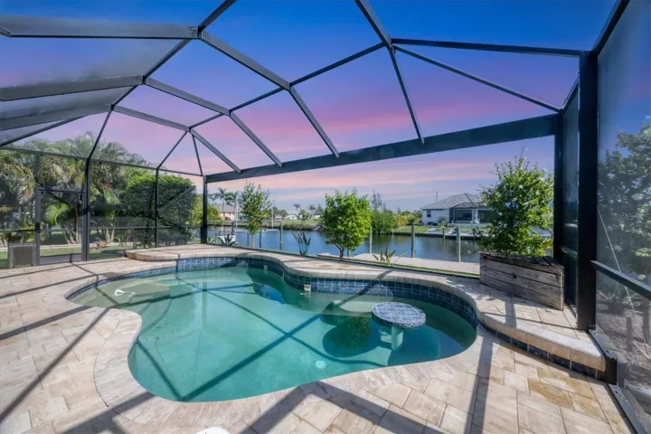 step ups in corners great place for potted plants, palms,etc.  Notice seat and table right side of pool for cooling off with beverage of choice