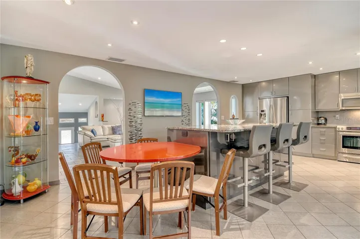 Another view of this fantastic kitchen highlights its thoughtful layout, upscale finishes, and seamless connection to the indoor and outdoor living spaces.