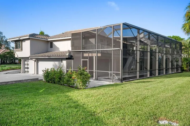 The rear view of the home highlights its meticulous maintenance and care, featuring a newer roof and an updated drainage system for lasting peace of mind.