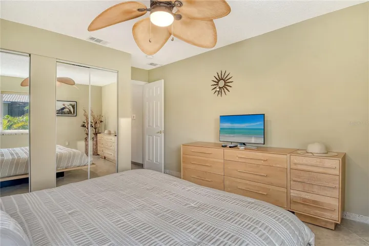 This second bedroom offers ample closet space and convenient access to a second full bathroom, making it perfect for guests.