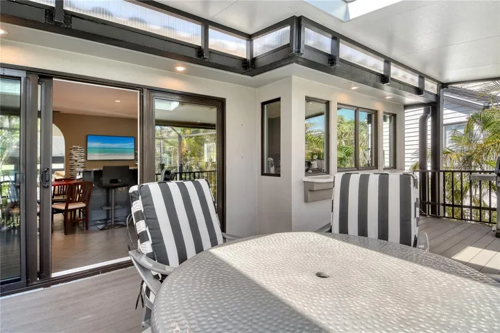 This outdoor area accessed from the kitchen, is perfect for al fresco dining, grilling, and entertaining, all within the comfort of a spacious screened in setting with skylights.