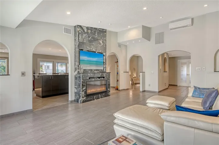 Graceful archways frame the space, complemented by updated flooring and fresh, modern tile colors for a stylish feel.
