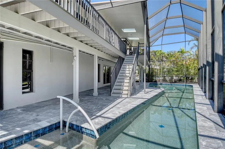 The pool area is accessible from both the upper deck and lower level patio, beautifully designed and in excellent condition.