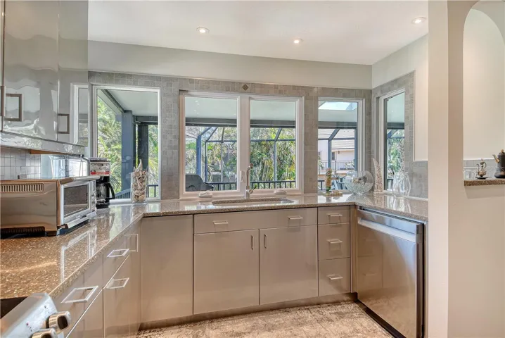 Sink area offers serene view of the private, lush backyard and pool area creating a fabulous backdrop for every day living.