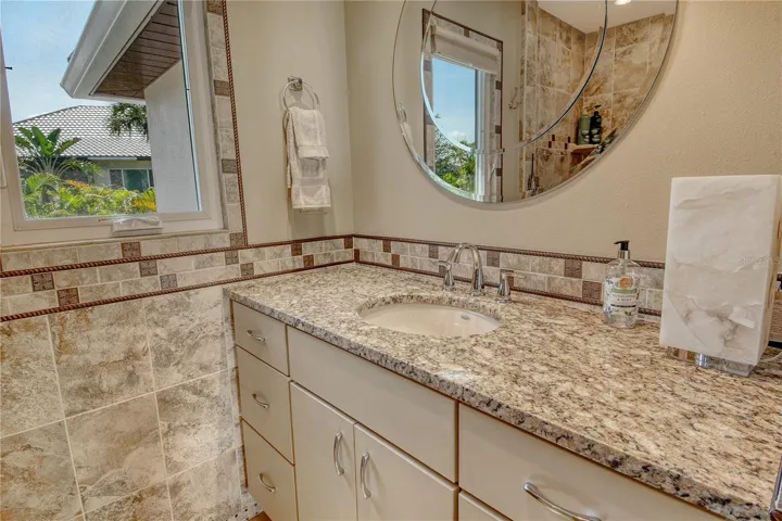 Another view of second full bathroom showcases a bright and airy feel with natural light.