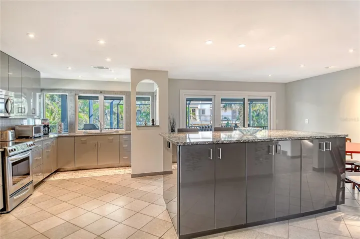 Updated kitchen showcases stylish design with a spacious island, sunny eat in area, abundant cabinetry, and generous counter space ideal for cooking and entertaining.