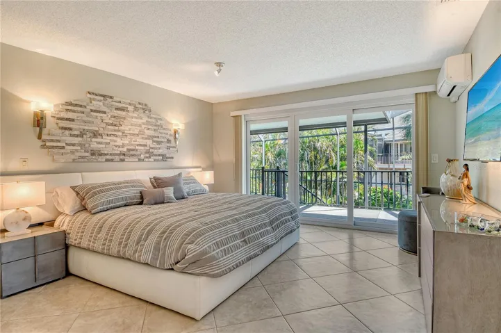 This primary suite exudes the ambiance of a private luxury spa.  Sleek sliders open to an intimate covered deck area.