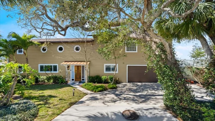 Exterior front photo of 2306 John Anderson Dr., Ormond Beach, Intracoastal Waterway views, Charming two story home with tropical landscaping, Boat lift and dock, large primary suite