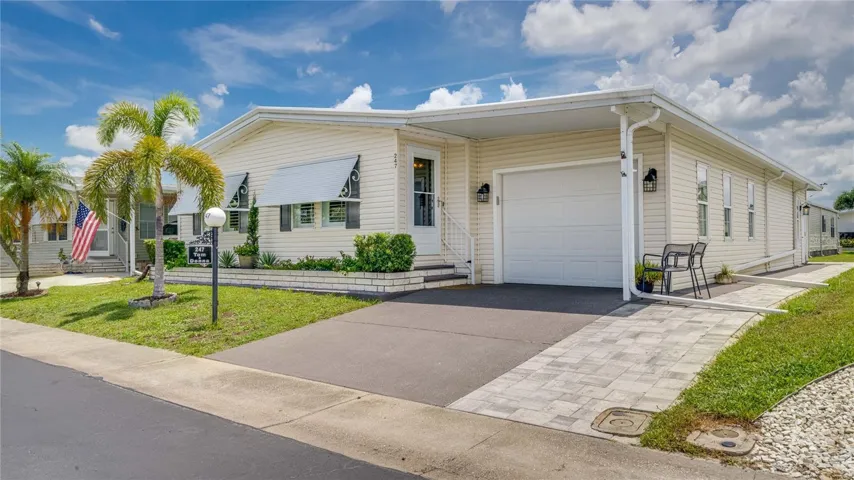 Take note of the garage and the new, custom brick golf cart path leading to the rear custom patio.