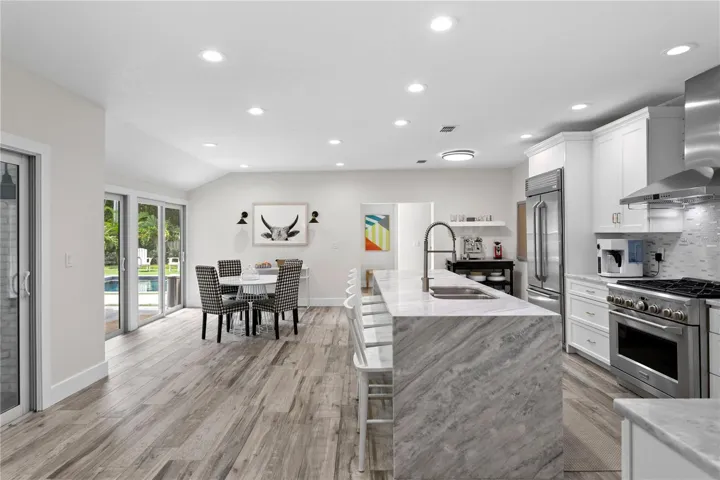 Multiple sliders off the Kitchen allows for easy access to your backyard oasis and natural light galore!