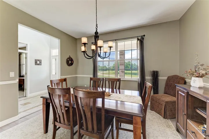 Dining Room off Kitchen and Foyer with Double Window Views of Front Lawn