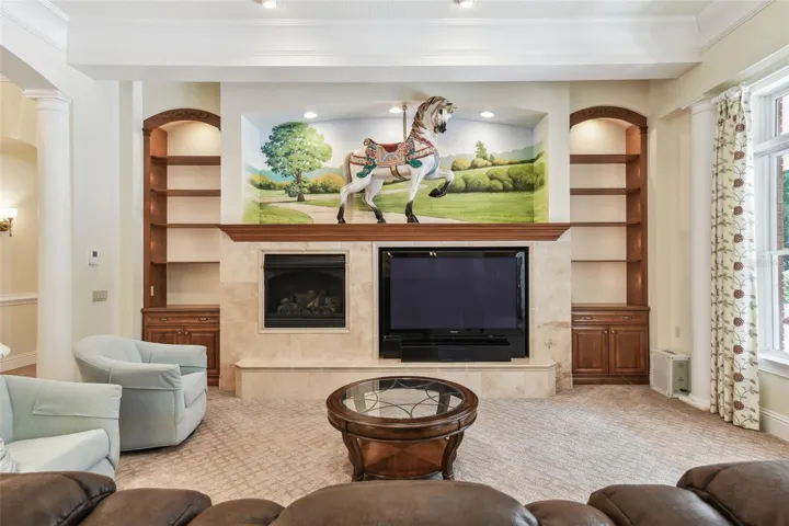 mpressive grand room features a gas fireplace, custom built-ins, surround sound, and a one-of-a-kind original carousel house centerpiece that adds character and charm.