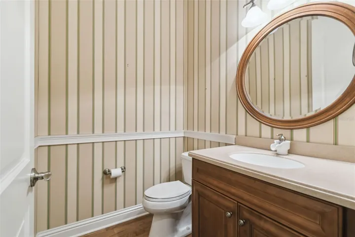 Convenient half bath situated between the kitchen and garage for easy access.