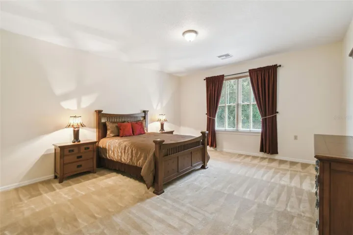 Upstairs features a spacious landing and inviting sitting room. Adjacent to the sitting area is a private guest suite with a connected full bathroom, along with an additional bedroom. The sitting room also includes a convenient kitchenette with a compact countertop, cabinet storage, sink, and mini refrigerator—perfect for guests or relaxing upstairs.