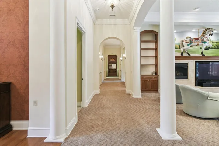 Hardwood flooring lies beneath the carpet in the hallway, offering a simple opportunity to restore or customize the floors to your preference.