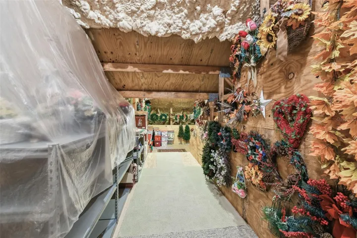 Upstairs, on either side of the guest suite and sitting room, are doorways leading to two spacious attic areas, both offering abundant storage. The attic above the garage is equipped with a 400 lb capacity electric lift, providing an easy and efficient way to move items between the garage and attic.