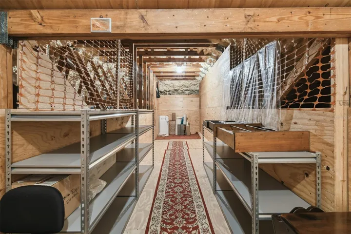Upstairs, on either side of the guest suite and sitting room, are doorways leading to two spacious attic areas, both offering abundant storage. The attic above the garage is equipped with a 400 lb capacity electric lift, providing an easy and efficient way to move items between the garage and attic.