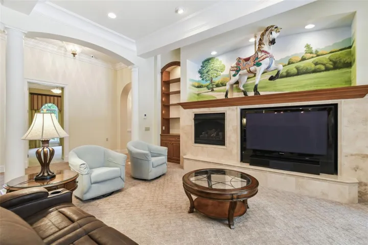 mpressive grand room features a gas fireplace, custom built-ins, surround sound, and a one-of-a-kind original carousel house centerpiece that adds character and charm.