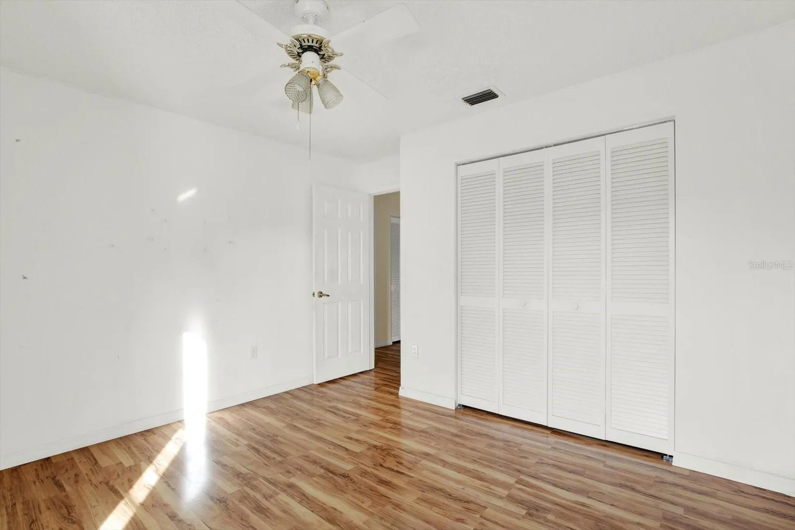 A second view of the second bedroom, showing the closet.