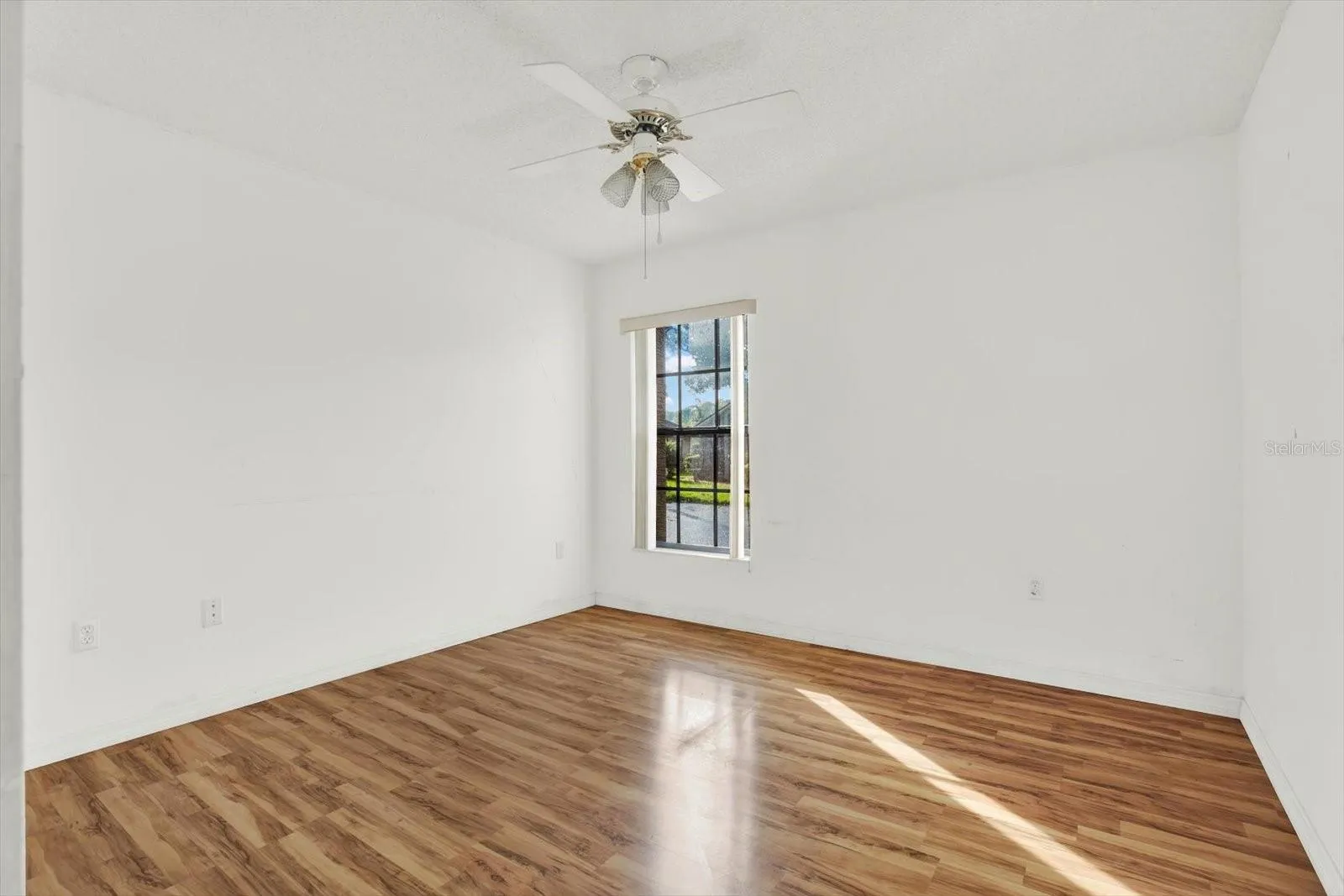The second bedroom, with natural light from the corner window