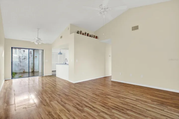 The living room opens directly to the kitchen, with a sliding glass door out to the lanai.