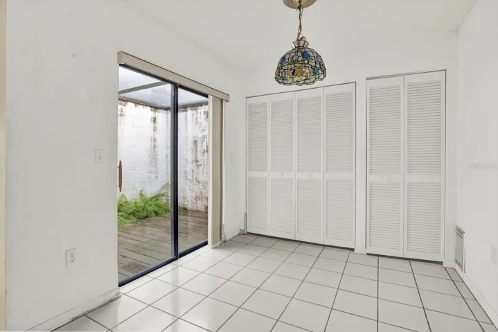 The dining nook, with a sliding glass door to the lanai and laundry closet.