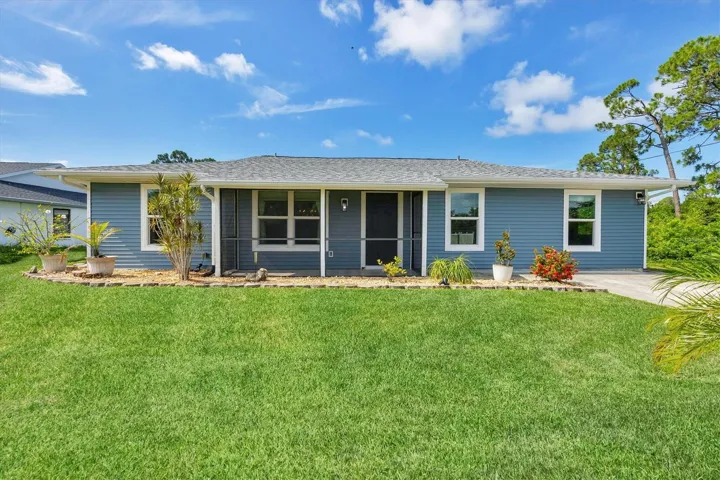 Charming and fully updated curb appeal with a new roof, fresh siding, and beautifully manicured lawn!