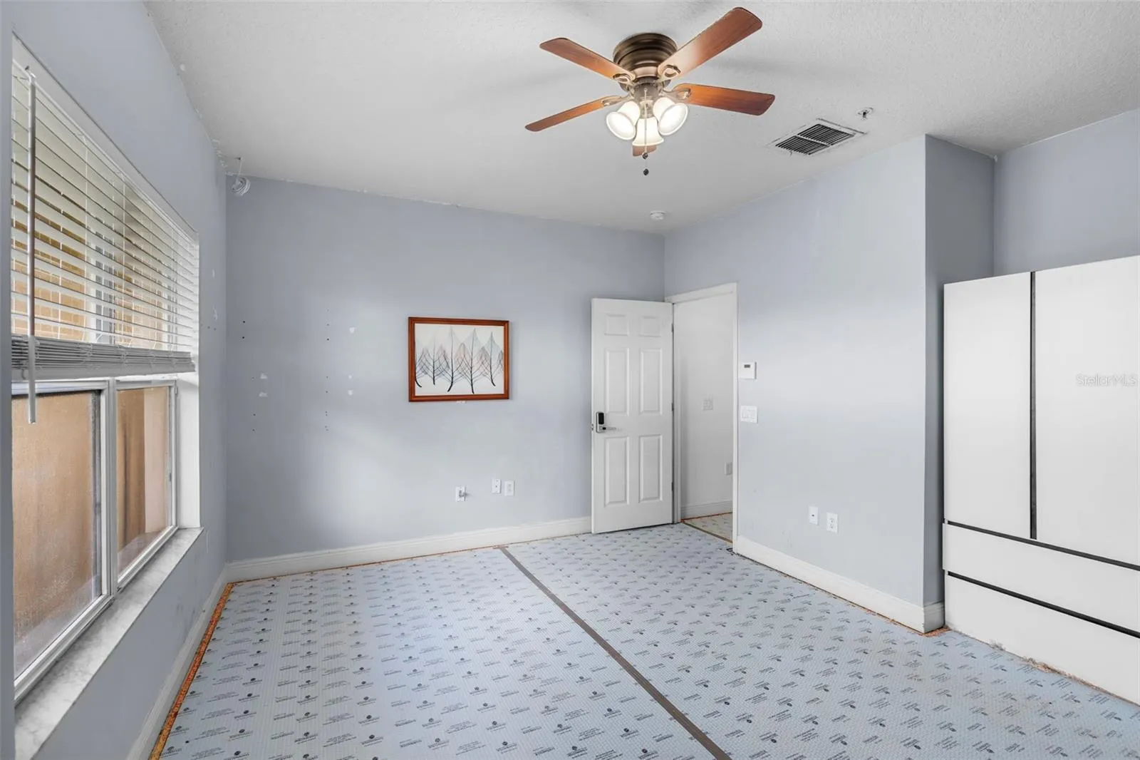 Primary bedroom with armoire