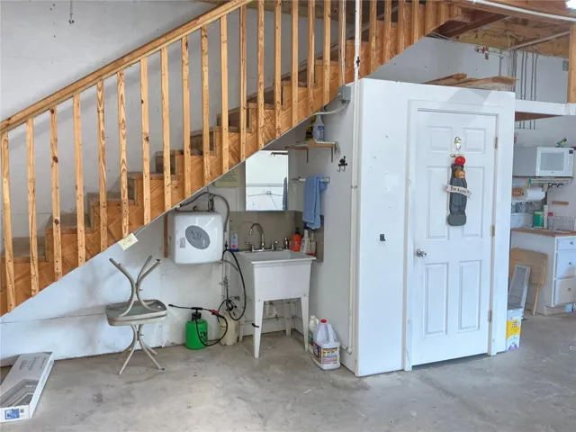 Garage, stairs to the upstairs, laundry tub w on demand hot waterGarage