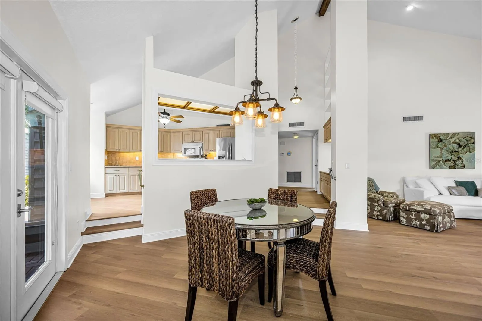 Upon entering you have a large living room, dining room and open kitchen area with volume ceilings and so much natural light. The door to the left is the breezeway which leads to the garage!
