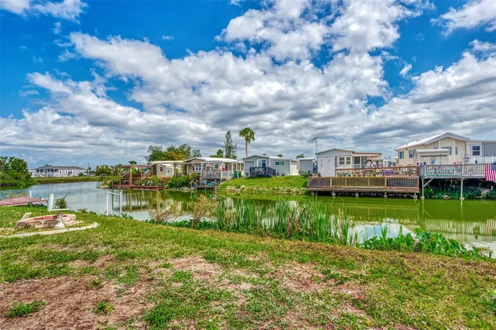 AS YOU LOOK TO THE LEFT, THE RED FISH WATERWAY TRAVELS AROUND THE CORNER TO A LAKE IN THE DISTANCE.