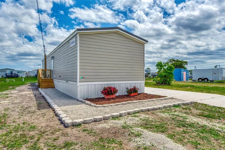 NOTE THE WALKWAY TO THE BACK DOOR.  HOME HAS BEEN DESIGNED FOR WIND'LOAD ZONES iii, (110 mph).