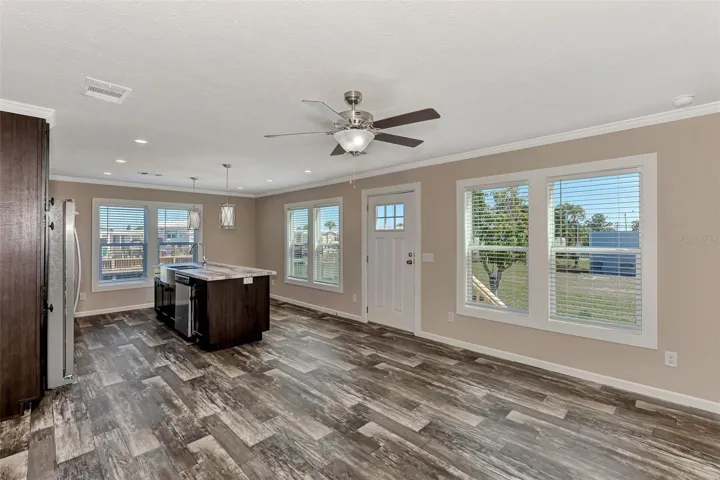 Front door entrance into the kitchen, living room area of this brand new home.