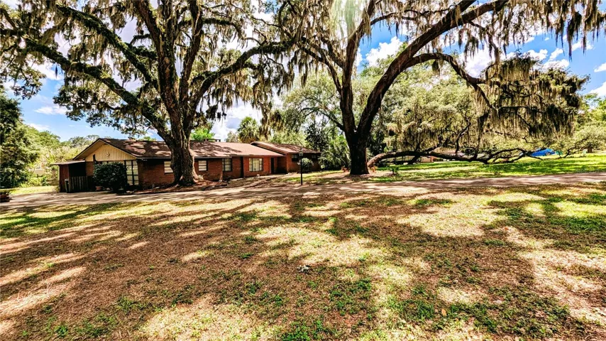 Brick Ranch with mature oaks throughout the property on the canal