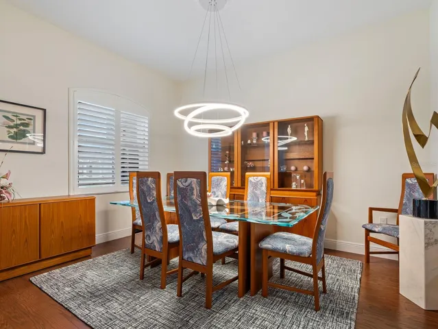 Dining Room with Amazing Chandelier, wood floors and plantation shutters