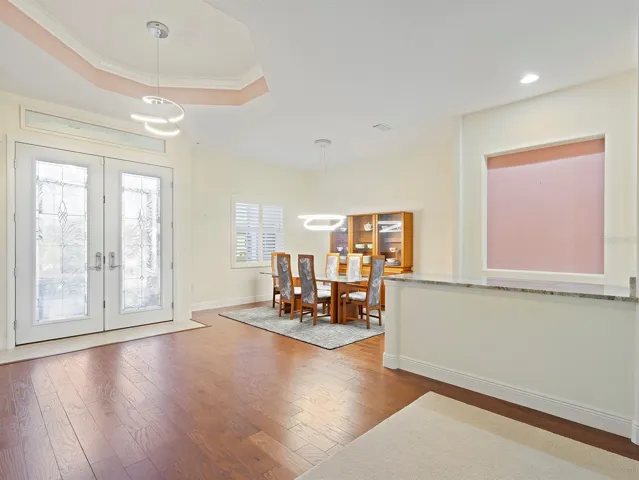 Foyer with tray ceiling, dining room and butler's pantry/bar