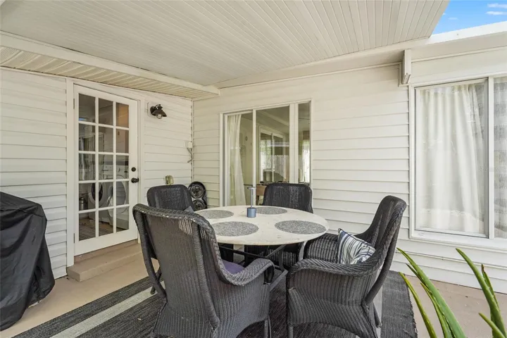 Covered Dining Patio – Dine alfresco under a covered lanai complete with fan, grill station, and cozy all-weather seating—a must-have feature for guests or year-round Florida living.