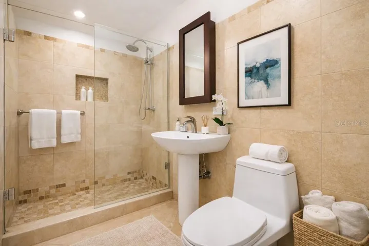 Bathroom: Full bathroom with walk-in shower and contemporary fixtures. AI-generated/AI-enhanced image for illustrative purposes.