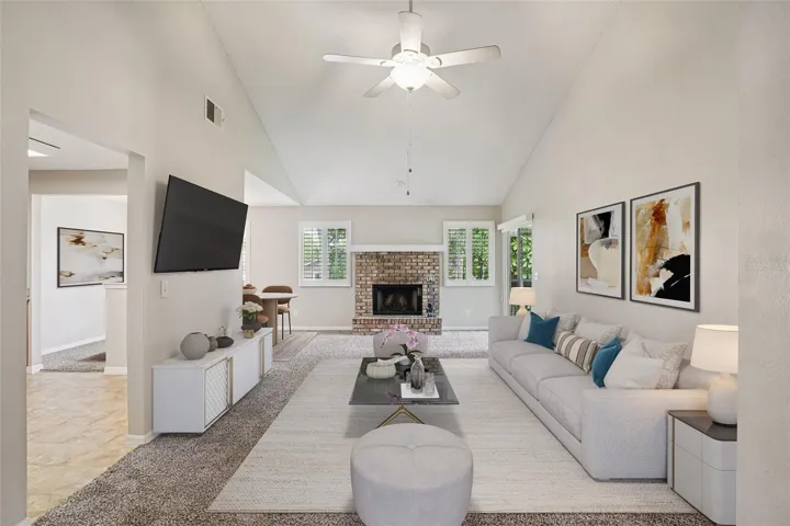 Inside you will be pleased to find a bright, OPEN LIVING SPACE with VAULTED CEILINGS, a cozy WOOD BURNING FIREPLACE, and PLANTATION SHUTTERS that add character and privacy. Virtually Staged.