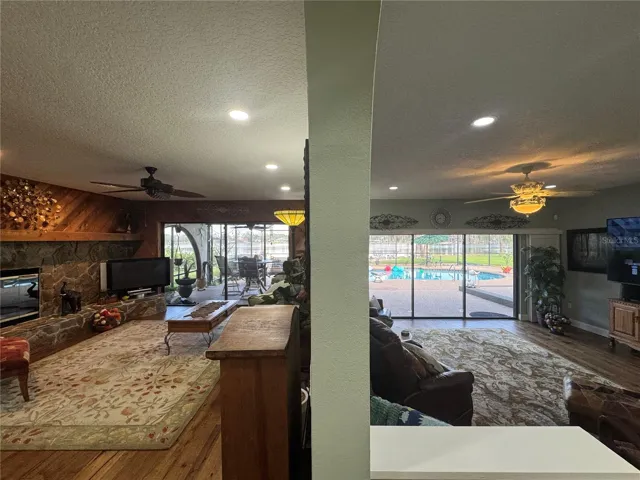 Family rooom on left & living room on right of wall.  Views off private pool & lake along entire back of house from inside.