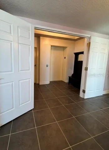 DOUBLE DOOR ENTRY INTO CONDO FROM FOYER