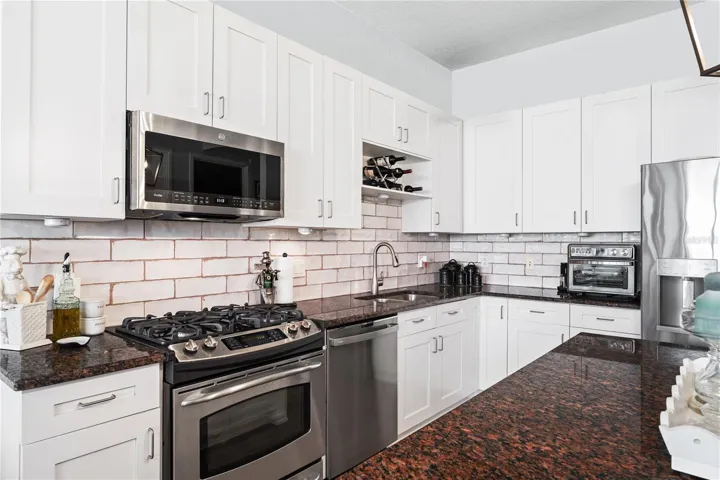 Sleek Modern Kitchen, gas range, new GE microwave, dishwasher and double door refrigerator