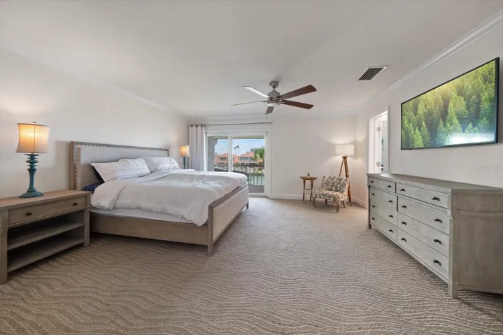 Primary suite is grand and offers private access to a balcony overlooking the canal.