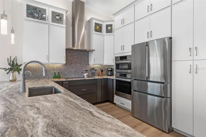 Striking leathered Granite countertops, custom cabinetry, and top-tier stainless appliances define this elegant and functional chef’s kitchen.