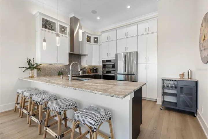 Sophisticated and functional with generous prep space, ample storage, and bar seating for casual dining.