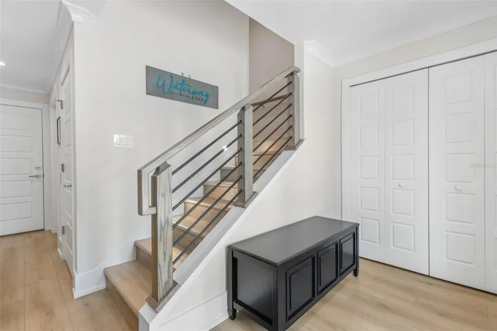 This inviting stairway that leads to the main living area on the third floor and four private guest retreats on the second.